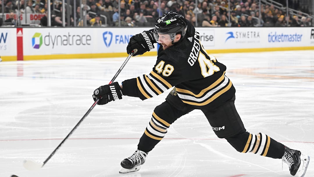 Feb 15, 2024; Boston, Massachusetts, USA; Boston Bruins defenseman Matt Grzelcyk (48) shoots the puck against the Seattle Kraken during the third period at the TD Garden. Mandatory Credit: Brian Fluharty-Imagn Images