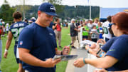 New Seahawks coach Mike Macdonald signs autographs after training camp at Virginia Mason Athletic Center.