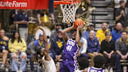 Feb 25, 2025; Morgantown, West Virginia, USA; TCU Horned Frogs guard Jace Posey (41) shoots in the lane over West Virginia Mountaineers guard Javon Small (7) during the second half at WVU Coliseum. Mandatory Credit: Ben Queen-Imagn Images