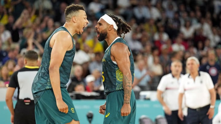 Aug 6, 2024; Paris, France; Australia point guard Dante Exum (11) celebrates with guard Patty Mills (5) after a play against Serbia in men’s basketball quarterfinals during the Paris 2024 Olympic Summer Games at Accor Arena. Mandatory Credit: Kyle Terada-USA TODAY Sports