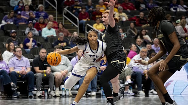 TCU Horned Frogs guard Taylor Bigby (1) handles the ball while being defended by Colorado Buffaloes forward Tabitha Betson (1