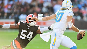 Nov 3, 2024; Cleveland, Ohio, USA; Cleveland Browns defensive end Ogbo Okoronkwo (54) chases Los Angeles Chargers quarterback Justin Herbert (10) during the second half at Huntington Bank Field.