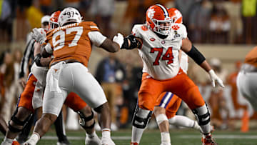 Dec 21, 2024; Austin, Texas, USA; Texas Longhorns defensive lineman Alex January (97) and Clemson Tigers offensive lineman Marcus Tate (74) in action during the game between the Texas Longhorns and the Clemson Tigers in the CFP National Playoff First Round at Darrell K Royal-Texas Memorial Stadium. Mandatory Credit: Jerome Miron-Imagn Images