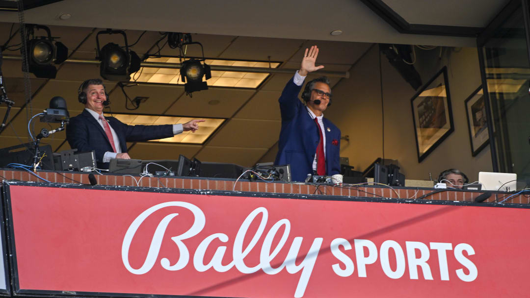 Mar 30, 2023; St. Louis, Missouri, USA;  Bally Sports Midwest announcer Chip Caray and Brad Thompson wave to the fans during the second inning of an opening day game between the St. Louis Cardinals and the Toronto Blue Jays at Busch Stadium. Mandatory Credit: Jeff Curry-USA TODAY Sports