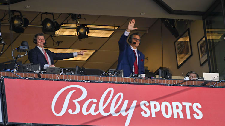 Mar 30, 2023; St. Louis, Missouri, USA;  Bally Sports Midwest announcer Chip Caray and Brad Thompson wave to the fans during the second inning of an opening day game between the St. Louis Cardinals and the Toronto Blue Jays at Busch Stadium. Mandatory Credit: Jeff Curry-USA TODAY Sports