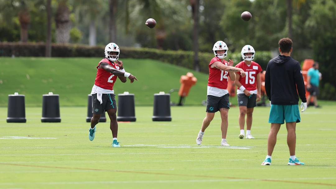 Miami Dolphins quarterback Malik Willis (2) and backup quarterback Quinn Ewers (14) throwing during minicamp with Cam Miller (15) observing at the Baptist Health Training Complex.