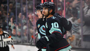 Jan 25, 2025; Seattle, Washington, USA; Seattle Kraken right wing Kaapo Kakko (84) and center Matty Beniers (10) celebrate after Beniers scored a goal against the Pittsburgh Penguins during the third period at Climate Pledge Arena. Mandatory Credit: Steven Bisig-Imagn Images