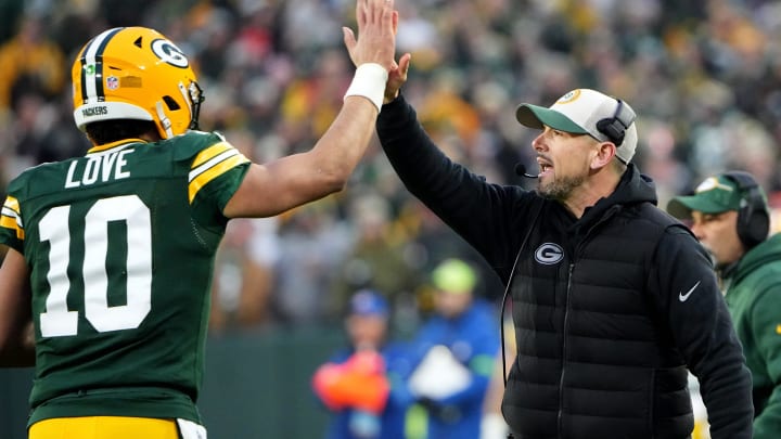 Green Bay Packers quarterback Jordan Love (10) high fives head coach Matt LaFleur after throwing a touchdown pass during the second quarter of their game against the Chicago Bear Sunday, January 7, 2024 at Lambeau Field in Green Bay, Wisconsin.