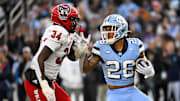 North Carolina Tar Heels running back Omarion Hampton (28) with the ball as North Carolina State Wolfpack linebacker Kamal Bonner (34) defends in the first quarter at Kenan Memorial Stadium. 