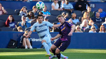 May 4, 2025; Kansas City, Kansas, USA; Sporting Kansas City forward Shapi Suleymanov (93) takes a shot on goal as LA Galaxy defender Maya Yoshida (4) looks on during the first half at Children's Mercy Park. Mandatory Credit: Denny Medley-Imagn Images