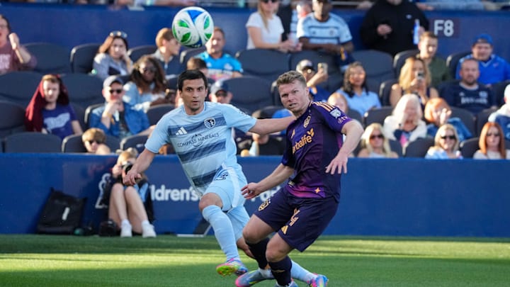 May 4, 2025; Kansas City, Kansas, USA; Sporting Kansas City forward Shapi Suleymanov (93) takes a shot on goal as LA Galaxy defender Maya Yoshida (4) looks on during the first half at Children's Mercy Park. Mandatory Credit: Denny Medley-Imagn Images