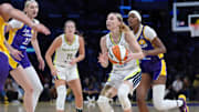 Aug 20, 2025; Los Angeles, California, USA; Dallas Wings guard Paige Bueckers (5) is defended by LA Sparks forward Cameron Brink (22) and forward Rickea Jackson (2) in the first half at Crypto.com Arena. Mandatory Credit: Kirby Lee-Imagn Images