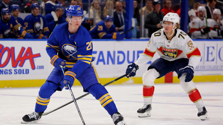 Oct 28, 2024; Buffalo, New York, USA;  Buffalo Sabres defenseman Rasmus Dahlin (26) control the puck as Florida Panthers center Jesper Boqvist (70) defends during the first period at KeyBank Center. Mandatory Credit: Timothy T. Ludwig-Imagn Images