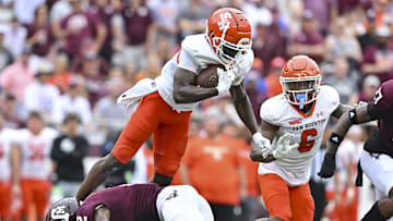 Sep 3, 2022; College Station, Texas, USA;  Texas A&M Aggies defensive back Denver Harris (2) upends Sam Houston State Bearkats wide receiver Ife Adeyi (2) during the first quarter at Kyle Field. Mandatory Credit: Maria Lysaker-Imagn Images