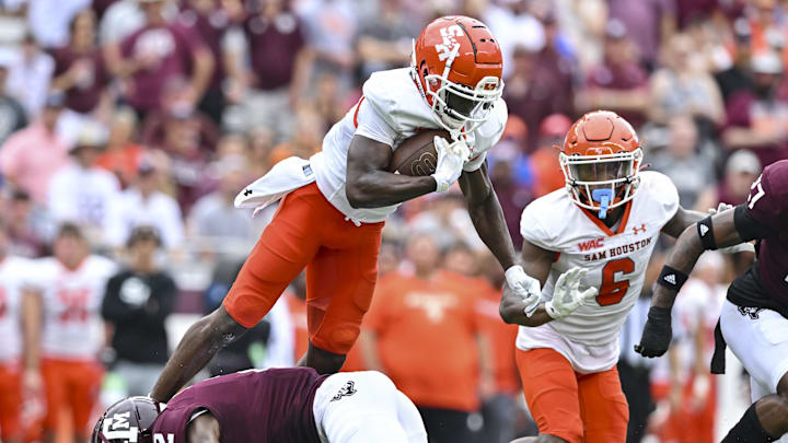 Sep 3, 2022; College Station, Texas, USA;  Texas A&M Aggies defensive back Denver Harris (2) upends Sam Houston State Bearkats wide receiver Ife Adeyi (2) during the first quarter at Kyle Field. Mandatory Credit: Maria Lysaker-Imagn Images