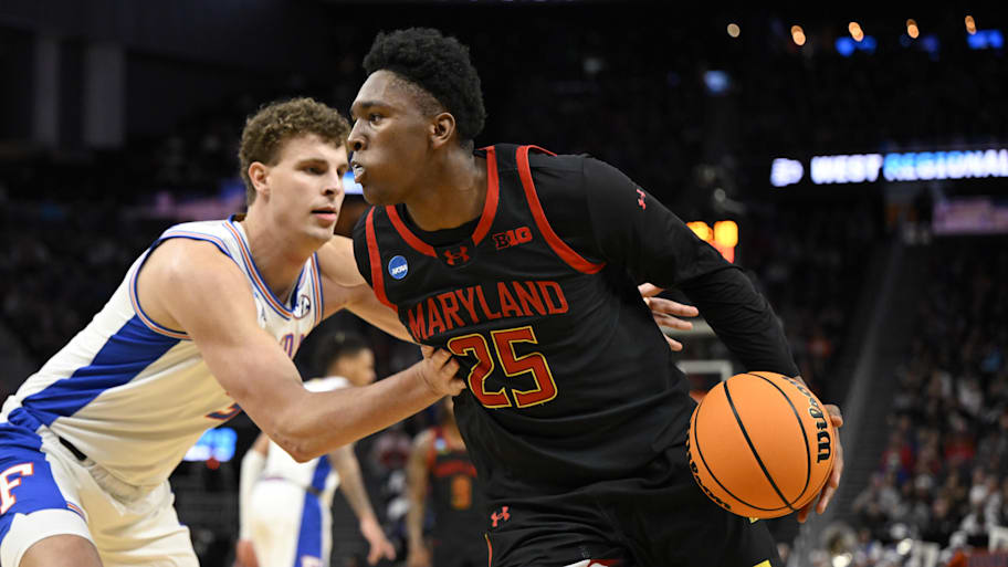 Maryland Terrapins center Derik Queen (25) drives to the hoop past Florida Gators center Micah Handlogten.