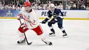 Apr 10, 2025; St. Louis, Missouri, UNITED STATES; Boston University Terriers forward Nick Roukounakis (7) controls the puck against the Penn State Nittany Lions during the first period of the Frozen Four college ice hockey national semifinals at Enterprise Center. Mandatory Credit: Jeff Curry-Imagn Images