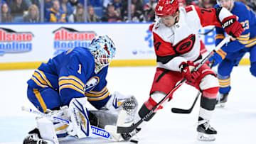Nov 23, 2025; Buffalo, New York, USA; Carolina Hurricanes center Seth Jarvis (24) tries to get the puck past Buffalo Sabres goaltender Ukko-Pekka Luukkonen (1) in the first period at KeyBank Center. Mandatory Credit: Mark Konezny-Imagn Images