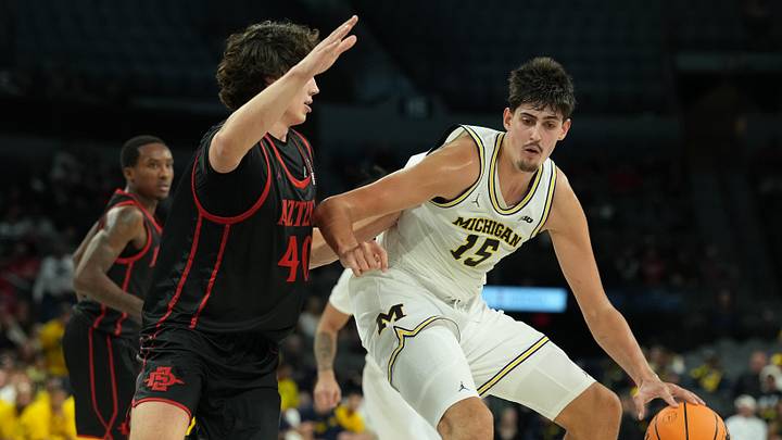 Nov 24, 2025; Las Vegas, Nevada, USA; Michigan Wolverines center Aday Mara (15) controls the ball against San Diego State Aztecs forward Miles Heide (40) during the first half in a 2025 Players Era Festival group play game at Michelob Ultra Arena. Mandatory Credit: Kirby Lee-Imagn Images