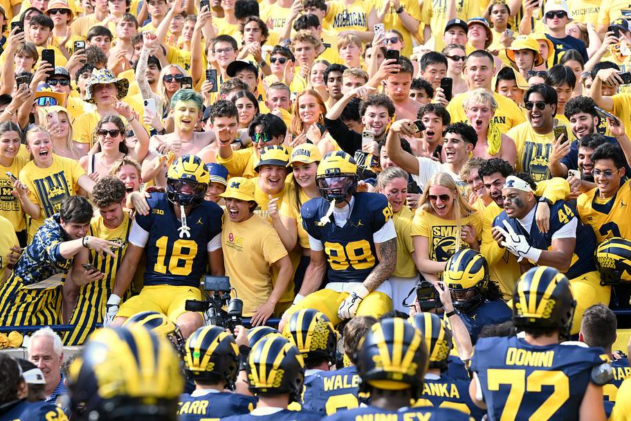 Wolverines players and fans celebrate after defeating the Sooners.