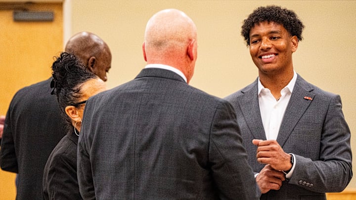 Ole Miss quarterback Trinidad Chambliss smiles while talking with his attorney William Liston during the hearing of Chambliss in his lawsuit against the NCAA at Calhoun County Courthouse in Pittsboro, Miss., on Thursday, Feb. 12, 2026. Chambliss is looking for a temporary injunction and a permanent injunction against the NCAA for one more year of eligibility.
