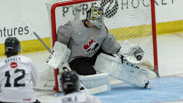 Aug 2, 2024; Plymouth, MI, USA; Canada's goaltender Joshua Ravensbergen (1) makes a glove save against Finland during the first period of the 2024 World Junior Summer Showcase at USA Hockey Arena.