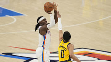 Jun 16, 2025; Oklahoma City, Oklahoma, USA; Oklahoma City Thunder guard Luguentz Dort (5) shoots a 3-pointer against Indiana Pacers guard Tyrese Haliburton (0) during the third quarter in Game 5 of the 2025 NBA Finals at Paycom Center. Mandatory Credit: Kyle Terada-Imagn Images