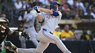 Jul 6, 2025; San Diego, California, USA; Texas Rangers shortstop Corey Seager (5) hits an RBI double during the first inning against the San Diego Padres at Petco Park. 