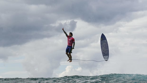 Surfer reacting after catching a wave at the 2024 Summer Olympics in Paris hosted in Tahiti.