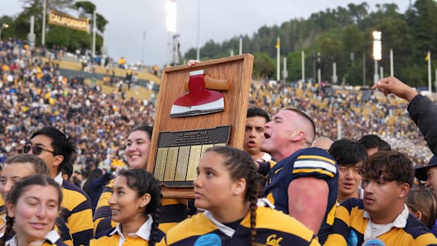 The California Golden Bears axe committee holds up the axe trophy with place kicker Ryan Coe (center right)