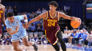 Minnesota Golden Gophers guard Cam Christie (24) rushes up the court against Indiana State Sycamores guard Julian Larry (1) on Sunday, March 24, 2024, during the second round of the NIT at the Hulman Center in Terre Haute. The Indiana State Sycamores defeated the Minnesota Golden Gophers, 76-64.