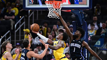 Apr 11, 2025; Indianapolis, Indiana, USA; Indiana Pacers guard Bennedict Mathurin (00) shoots the ball under Orlando Magic forward Jonathan Isaac (1) during the second half at Gainbridge Fieldhouse. Mandatory Credit: Marc Lebryk-Imagn Images