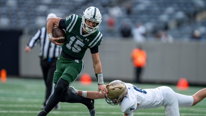 DePaul's Derek Zammit (15) breaks a tackle from Pope John's Sam Conetta (9) during the NJSIAA Non-Public B high school football championship game between DePaul and Pope John on Friday, Nov. 29 at MetLife Stadium.