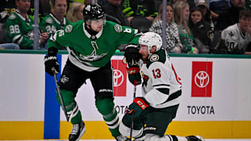 Oct 14, 2025; Dallas, Texas, USA; Dallas Stars defenseman Lian Bichsel (6) checks Minnesota Wild center Yakov Trenin (13) during the first period at the American Airlines Center. Mandatory Credit: Jerome Miron-Imagn Images