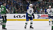 Apr 8, 2025; Dallas, Texas, USA; Vancouver Canucks left wing Jake DeBrusk (74) celebrates center Pius Suter (not pictured) scoring the game tying goal against the Dallas Stars during the third period at the American Airlines Center. Mandatory Credit: Jerome Miron-Imagn Images