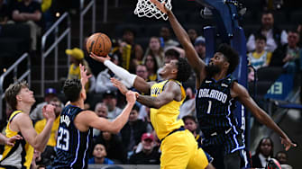 Apr 11, 2025; Indianapolis, Indiana, USA; Indiana Pacers guard Bennedict Mathurin (00) shoots the ball under Orlando Magic forward Jonathan Isaac (1) during the second half at Gainbridge Fieldhouse. Mandatory Credit: Marc Lebryk-Imagn Images