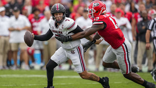 South Carolina Gamecocks QB Spencer Rattler (7) is pressured by Georgia Bulldogs defensive lineman Mykel Williams (13)