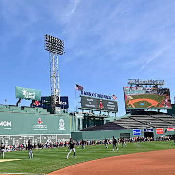 Apr 20, 2025; Boston, Massachusetts, USA; Fans line the field in front of the Green Monster as the Chicago White Sox warm up before a game at Fenway Park. Mandatory Credit: Eric Canha-Imagn Images