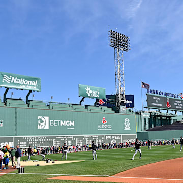 Apr 20, 2025; Boston, Massachusetts, USA; Fans line the field in front of the Green Monster as the Chicago White Sox warm up before a game at Fenway Park. Mandatory Credit: Eric Canha-Imagn Images