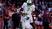 Sep 7, 2024; Blacksburg, Virginia, USA; Marshall Thundering Herd defensive lineman Mike Green (15) celebrates after sacking Virginia Tech Hokies quarterback Kyron Drones (1) during the first quarter at Lane Stadium. Mandatory Credit: Peter Casey-Imagn Images