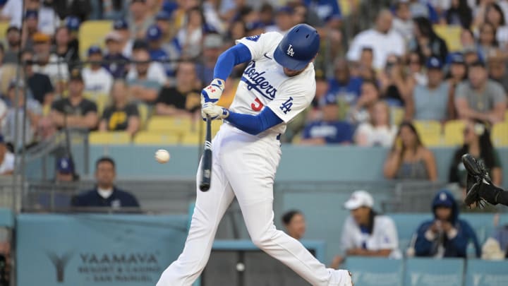 Aug 9, 2024; Los Angeles, California, USA; Los Angeles Dodgers first baseman Freddie Freeman (5) hits a solo home run in the first inning against the Pittsburgh Pirates at Dodger Stadium. Mandatory Credit: Jayne Kamin-Oncea-USA TODAY Sports