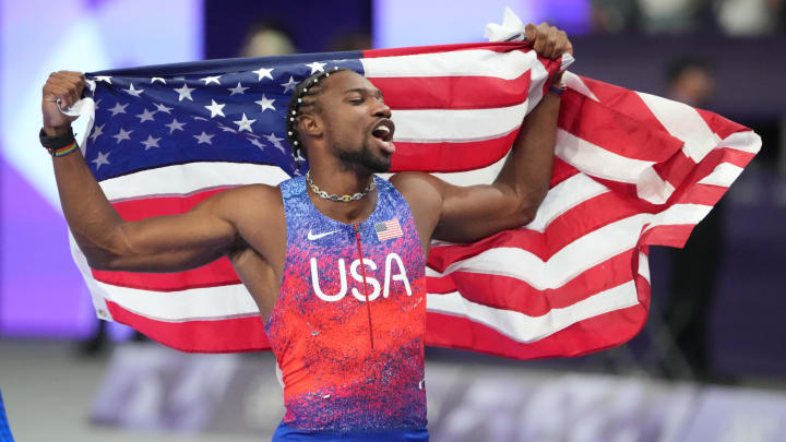 Aug 4, 2024; Paris, FRANCE; Noah Lyles (USA) celebrates winning the men's 100m final during the Paris 2024 Olympic Summer Games at Stade de France. Mandatory Credit: Kirby Lee-USA TODAY Sports