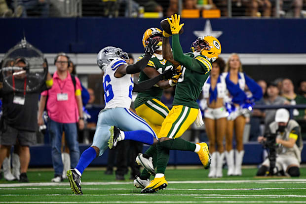 Green Bay Packers wide receiver Matthew Golden (0) catches a pass over Dallas Cowboys cornerback DaRon Bland.