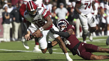 Nov 15, 2025; College Station, Texas, USA; South Carolina Gamecocks defensive back Vicari Swain (4) tackles South Carolina Gamecocks quarterback Lanorris Sellers (16) during the fourth quarter at Kyle Field. Mandatory Credit: Troy Taormina-Imagn Images
