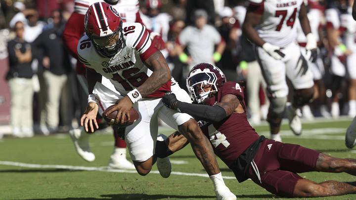 Nov 15, 2025; College Station, Texas, USA; South Carolina Gamecocks defensive back Vicari Swain (4) tackles South Carolina Gamecocks quarterback Lanorris Sellers (16) during the fourth quarter at Kyle Field. Mandatory Credit: Troy Taormina-Imagn Images