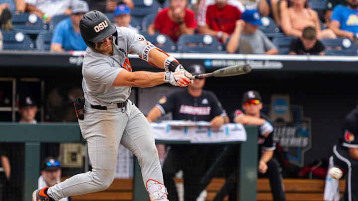 Jun 17, 2025; Omaha, Neb, USA; Oregon State Beavers designated hitter Tyce Peterson (54) hits a two RBI double against the Louisville Cardinals to tie the game in the ninth inning at Charles Schwab Field. Mandatory Credit: Dylan Widger-Imagn Images