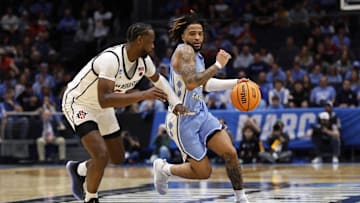 Mar 18, 2025; Dayton, OH, USA; North Carolina Tar Heels guard RJ Davis (4) dribbles the ball defended by San Diego State Aztecs forward Jared Coleman-Jones (31) .