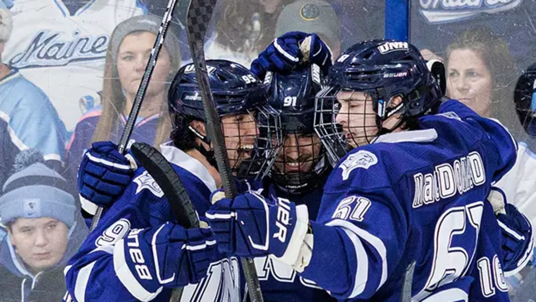 New Hampshire players celebrate a goal together against their rival Maine Black Bears on the road. 