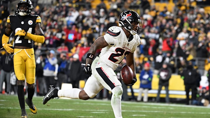 Jan 12, 2026; Pittsburgh, PA, USA; Houston Texans running back Woody Marks (27) scores a touchdown in front of Pittsburgh Steelers cornerback Joey Porter Jr. (24) during the second half of an AFC Wild Card Round game at Acrisure Stadium. Mandatory Credit: Barry Reeger-Imagn Images