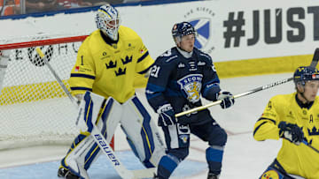 Aug 3, 2024; Plymouth, MI, USA; Finland's forward Joona Saarelainen (21) sets up in front of Sweden's goaltender Marcus Gidlof (1) during the first period of the 2024 World Junior Summer Showcase at USA Hockey Arena. Mandatory Credit: David Reginek-Imagn Images